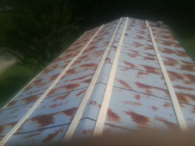 Rusted metal roof panels with new wood purlins before replacement — Storm Damage Roof Repair in Riverview by Roofing Brothers